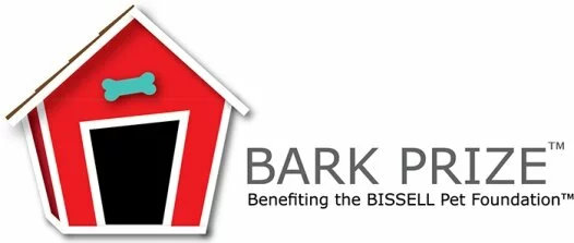 A red doghouse with a blue bone above the door appears next to the text BARK PRIZE Benefiting the BISSELL Pet Foundation.